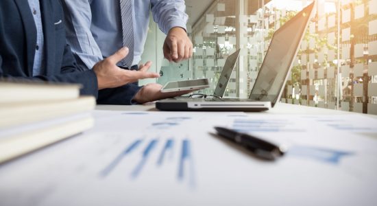 Business adviser analyzing financial figures denoting the progress in the work of the company.